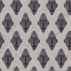 Vector cartoon seamless pattern of an ancient tribal mask in dark stone texture. Ethnic ceremonial artifact with abstract facial features, inspired by traditional African craftsmanship.