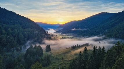 Obraz premium Sunrise valley. Misty mountains