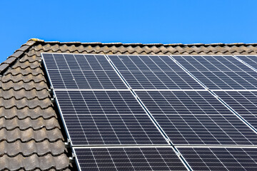 Photovoltaic panels producing renewable energy on a tiled roof