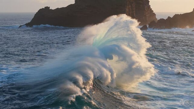 Slow motion epic shot of ocean wave splashing. Huge wave with turquoise water off the coast of the Atlantic Ocean. Big surf crash