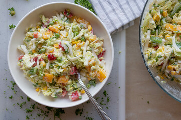 Chinese cabbage salad with peppers, onions, green peas in a delicious dressing. Tasty homemade barbecue salad