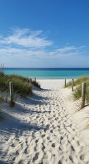 A serene beach path inviting you to a tranquil escape under a bright, sunny sky, with soft sand and footprints.