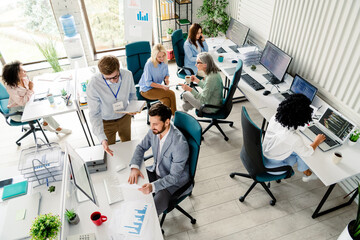 Group of business professionals collaborating in a modern open office workspace