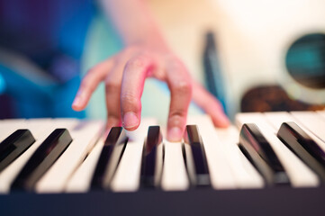 Asian teen girl playing guitar, composing music in home recording studio, LED lighting, at night...