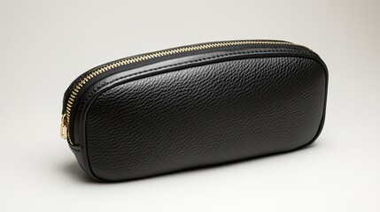 Naklejka premium A sleek black leather cosmetic bag with a gold zipper centered on a white background