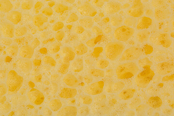 Yellow sponge texture background close up.