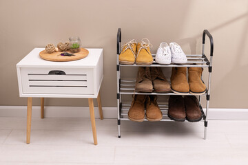 Stylish interior of modern hall with shoes on stand