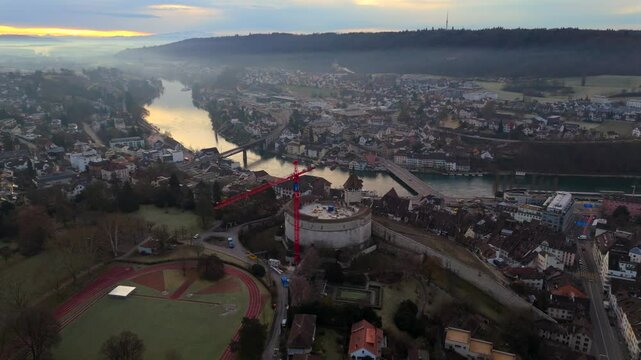 Panorama of Schaffhausen, Switzerland, showcasing historic city center, Emmersberg hill, and Rhinebruecke Schaffhausen-Feuerthalen. Misty morning light enhances beauty of this Swiss heritage site. 