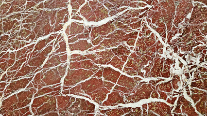 The polished red and pink marble, adorned with intricate white veins and streaks, exudes a sense of...