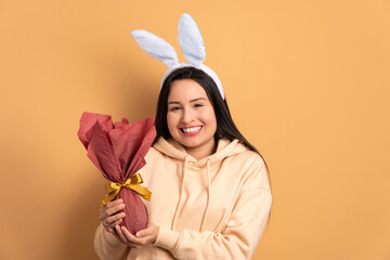 cheerful caucasian woman with easter egg in studio shot. holiday, easter, celebration concept.