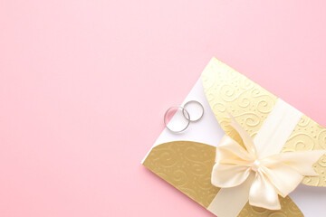 Wedding card mockup and wedding stationery on stone table. Pastel pink wedding envelopes, gold