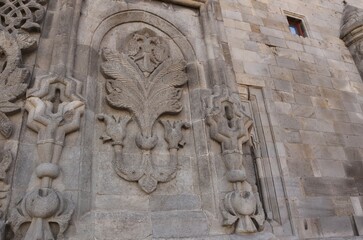Erzurum, Turkey. Stone carvings on Twin Minaret Madrasa’s exterior wall, featuring floral motifs and the iconic double-headed eagle— a stunning Seljuk architectural masterpiece.
