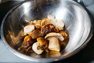 Fresh Raw Porcini Mushrooms in Metal Bowl.