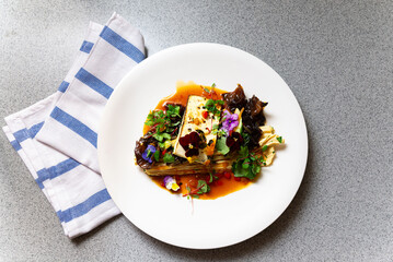 Gourmet tofu dish with wood ear mushrooms and sauce.