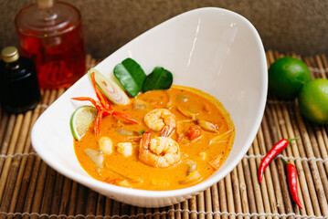 Thai Shrimp Tom Yum Soup with Herbs. Hot and creamy Thai tom yum soup with shrimp, lemongrass,...