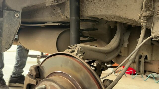 A technician is repairing the wheel section of a car