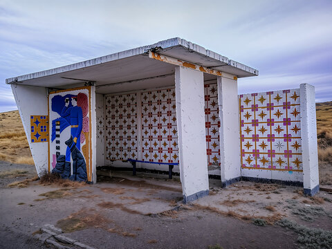The old Soviet bus stop in remote area of Kazakhstan, mural depicting USSR border guard with the dog, nearby Abai town in Kazakh steppe.
