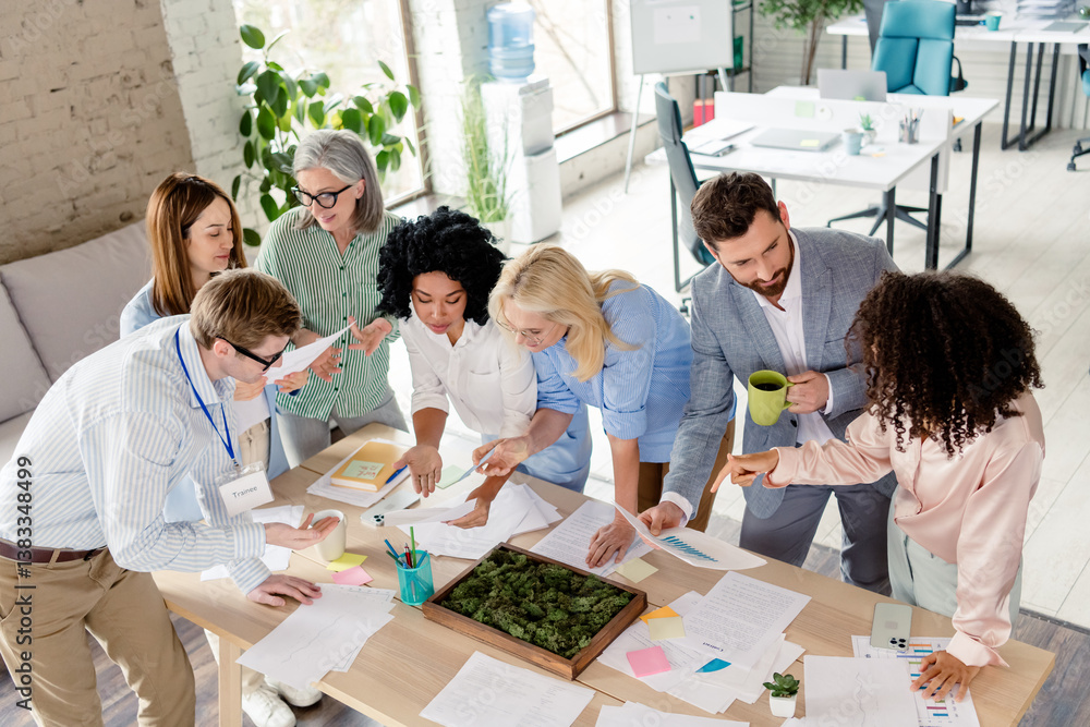 Poster diverse team working together in a modern office space, collaborating on a project with documents an