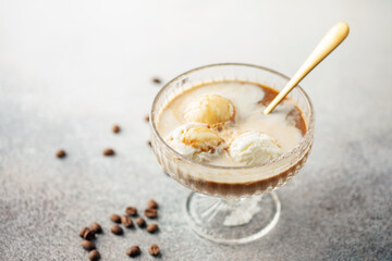 Vanilla ice cream ball with  coffee in glass.  Summer cocktail.