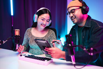 Teenagers, men and women, host podcasts in a room using LED lights, computers, headphones,...