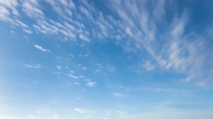 Obraz premium Light Blue Vault of Heaven, Filmy Clouds Wandering. The light blue sky is pure and vast. A few filmy clouds float leisurely, as if dancing gently, adding a touch of leisure and agility to the boundles