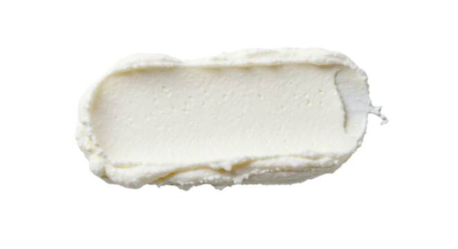 Close up view of a rectangular smear of white cream cheese against a solid black background space filling