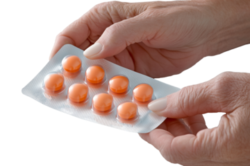 Hand of elderly woman holding medicine blister pack, isolated from transparent background.