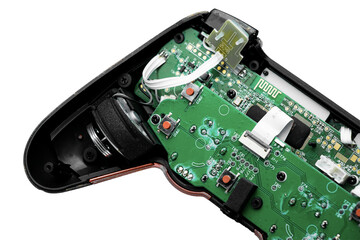 An opened black gaming controller with a green circuit board, buttons, and wires on a transparent background. Perfect for tech and repair visuals.   © Anastasiia