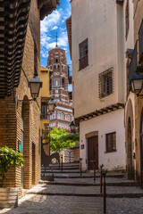 View of Torre de Utebo tower from the alley of Albarracin in the Poble Espanyol village open-air museum in summer, Barcelona, Catalonia, Spain