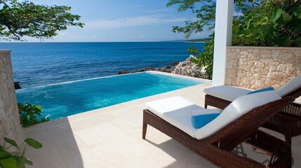 Obraz premium Luxury beachfront resort with an infinity pool, seamless ocean horizon view from a stylish hotel suite