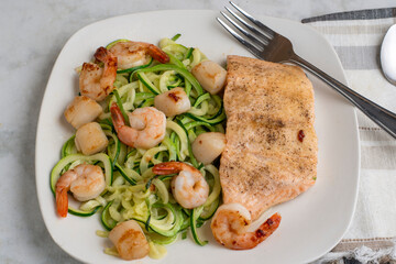 baked salmon  with zucchini noodles, shrimp and scallops
