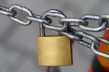 Locked securely, ensuring safety with a sturdy padlock on a chain link, representing protection in...