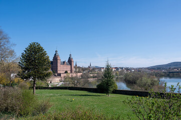 Fototapeta premium Aschaffenburg Castle with a river and a blue sky.
