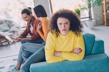 Woman Expressing Frustration while Two Friends Enjoy Relaxed Interaction in Modern Home during...