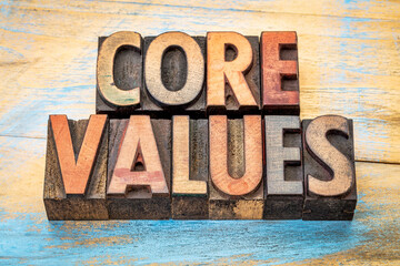 core values  banner  - text in vintage letterpress wood type blocks stained by color inks against...