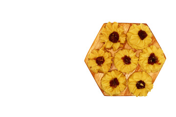 Kue semprit or Butter Cookies is a Traditional Indonesian Cookies, pineapple jam on top for Ied Al Fitr served on Wooden plate and isolated on white background 