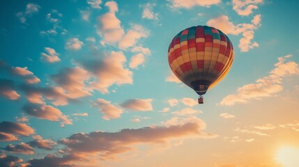 Obraz premium Colorful hot air balloon flying in blue sky with puffy clouds