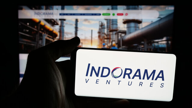 Stuttgart, Germany - 03-19-2025: Person holding mobile phone with logo of Thai petrochemical company Indorama Ventures on screen in front of web page. Focus on phone display.