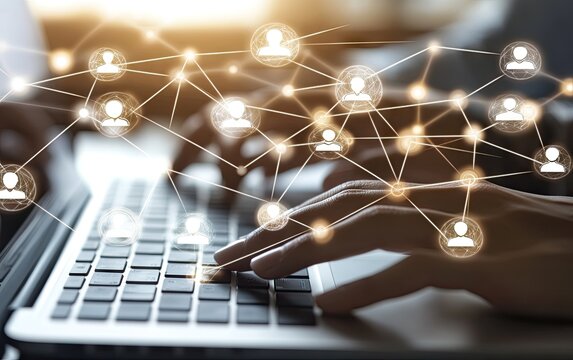 Hands typing on a laptop with a network of connected user icons