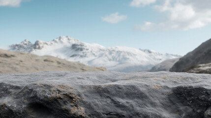 Obraz premium Scenic view of rocky terrain with snow-covered mountain peaks in the background, under a partly cloudy blue sky. Ideal background for nature and adventure themes.