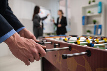 Office Professionals Playing Foosball During a Break in the Workplace