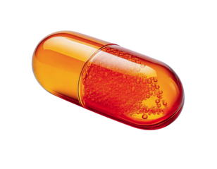 Closeup of a translucent amber capsule filled with effervescent orange liquid.