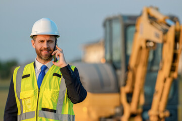 Business project advertisement. Building supervisor has phone call. Chief engineer in hardhat use...