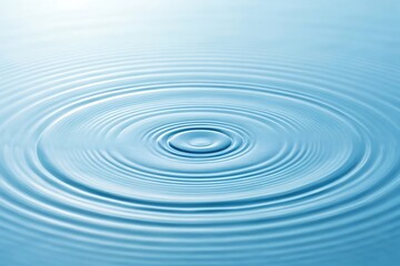 Tranquil ripples spreading outward from a single drop of water on a serene, pale blue surface.
