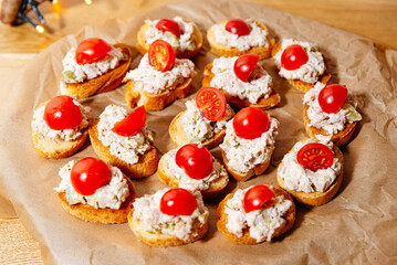 Mini bruschetta with tuna salad and cherry tomatoes.