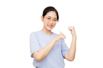 A young woman in a light blue shirt smiles while making a gesture with her hands, conveying enthusiasm and positivity.