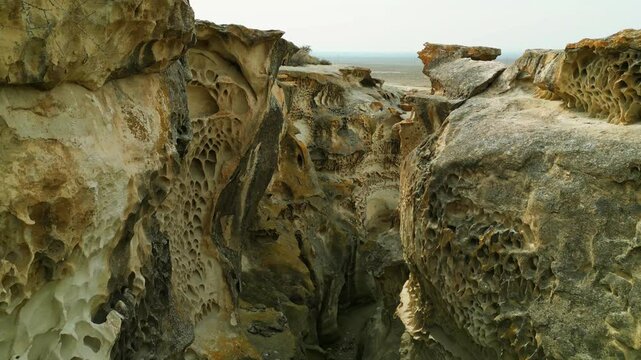 departure from the canyon with tafoni on the walls of ybykty sai inside through a narrow rocky openwork panorama from left to right kazakhstan mangystau 4k
