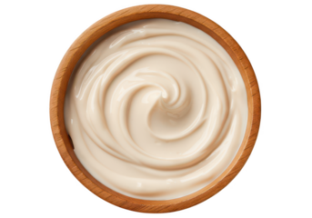 Overhead view of a wooden bowl filled with a creamy white swirl on a solid white background image