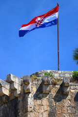 Historical Kamerlengo Fortress in Trogir, Croatia and Croatian flag.