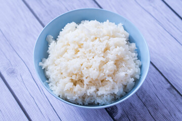 Rice in a bowl on top wood